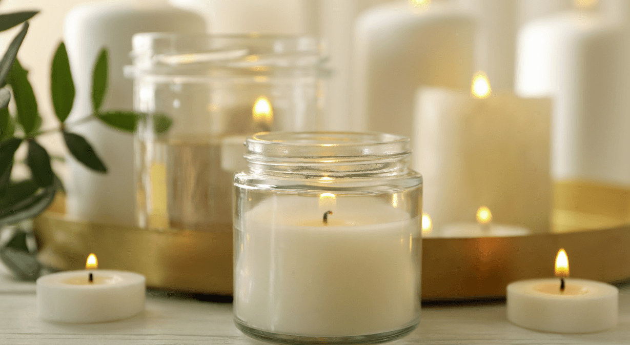 An image of various different sized candles alight