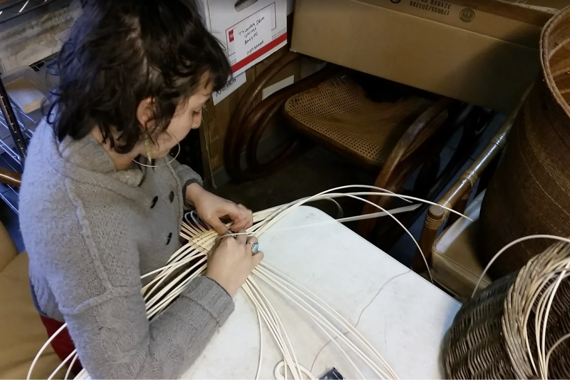 A closeup of a staff member weaving