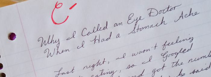 Close up of a school paper marked C- in red pen.