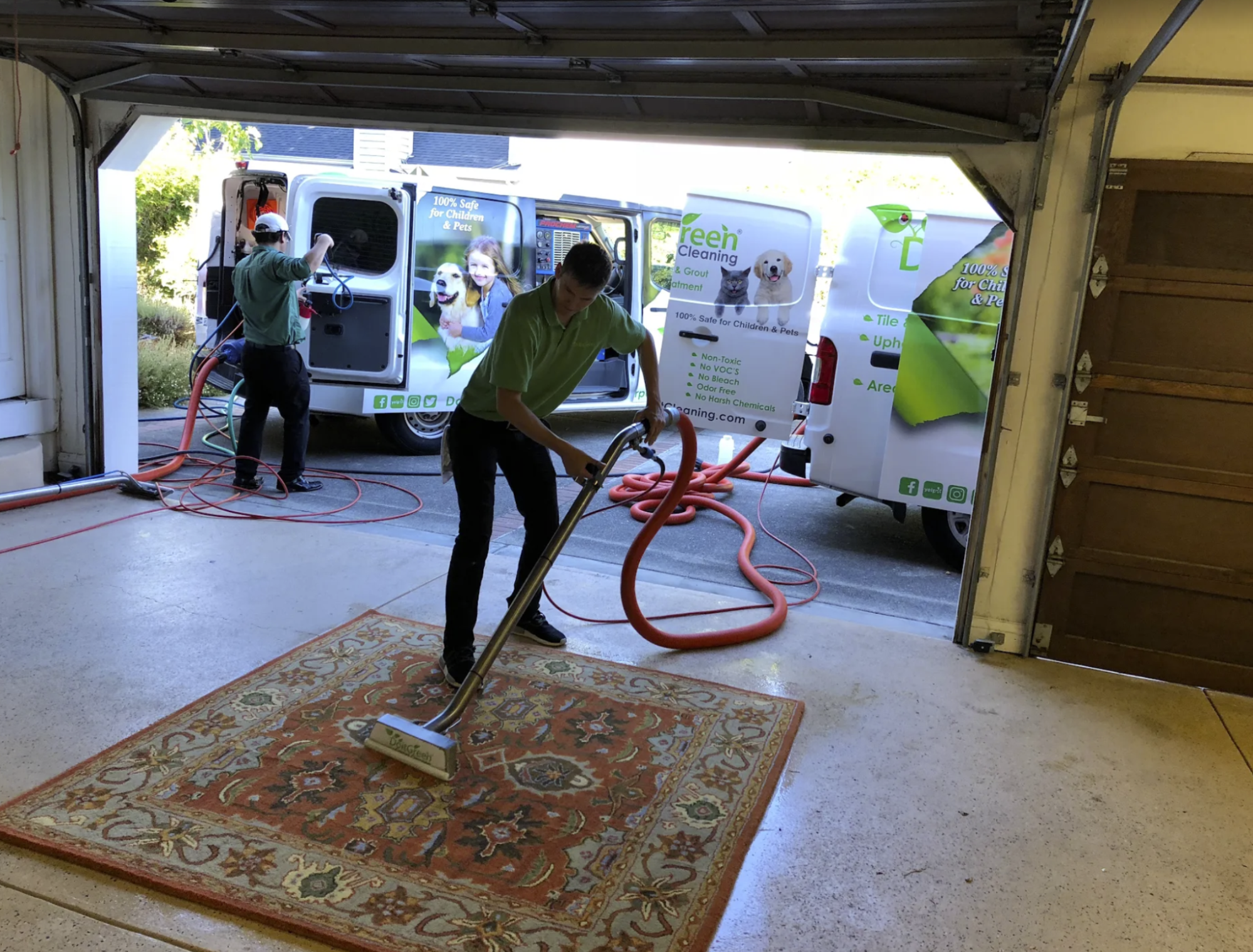 An action photo of staff cleaning a carpet with machinery