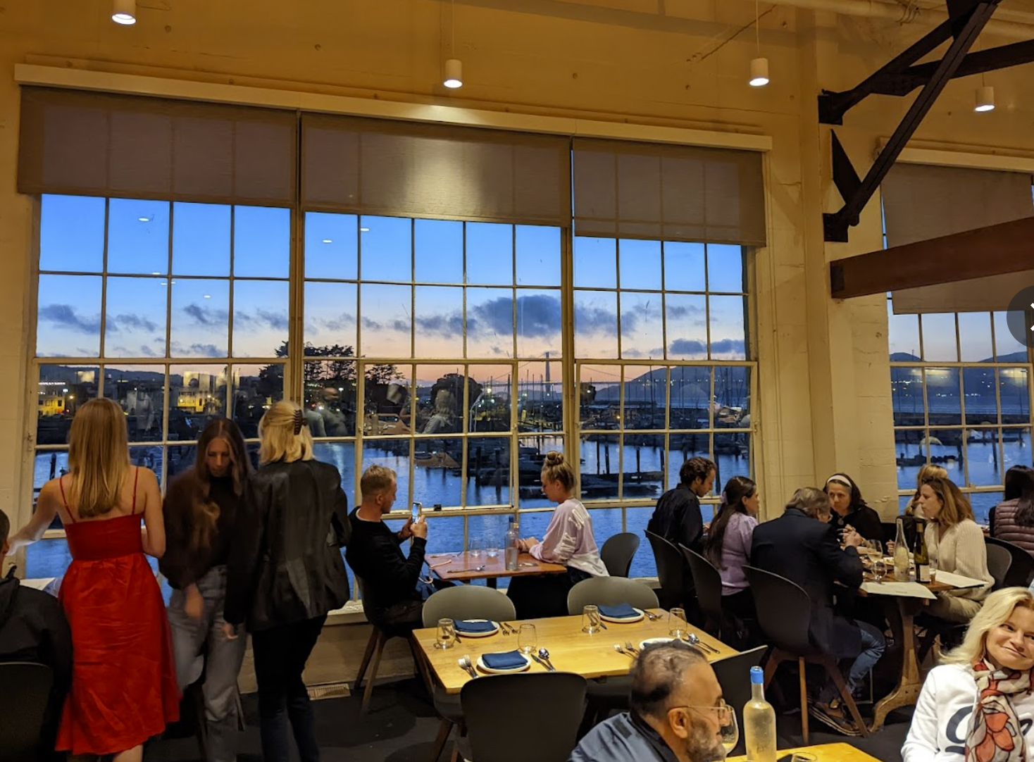 View of a restaurant filled with customers dining and walking around