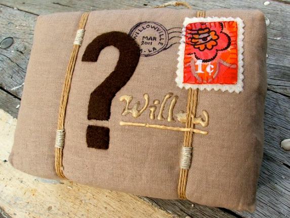 Christmas gift wrapped with question mark on it and red stamp.